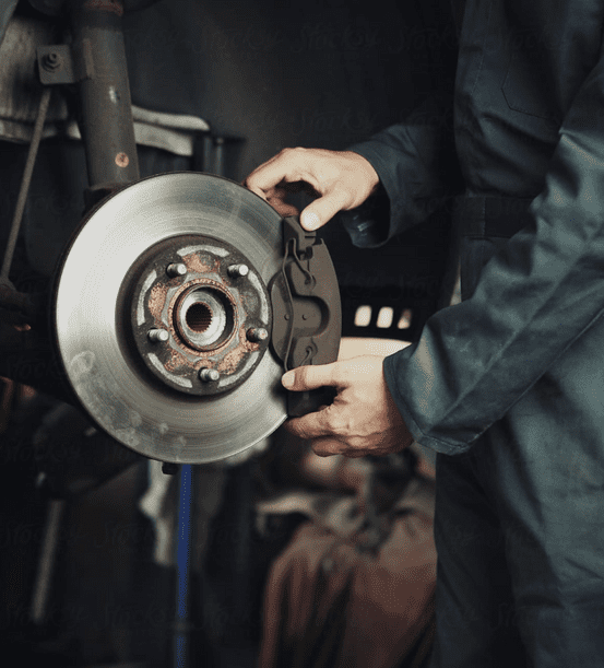 Mechanic installing brake caliper on rotor